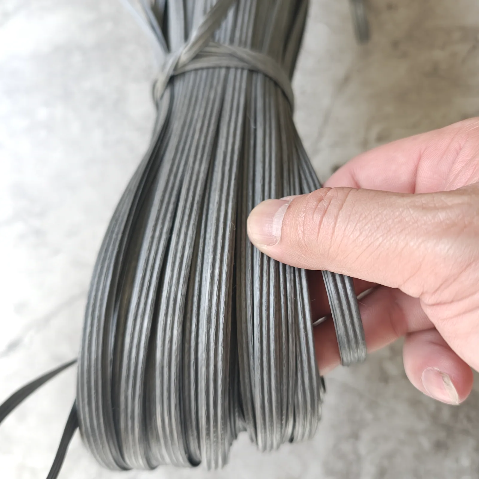 Black plastic tying material in finished coil form